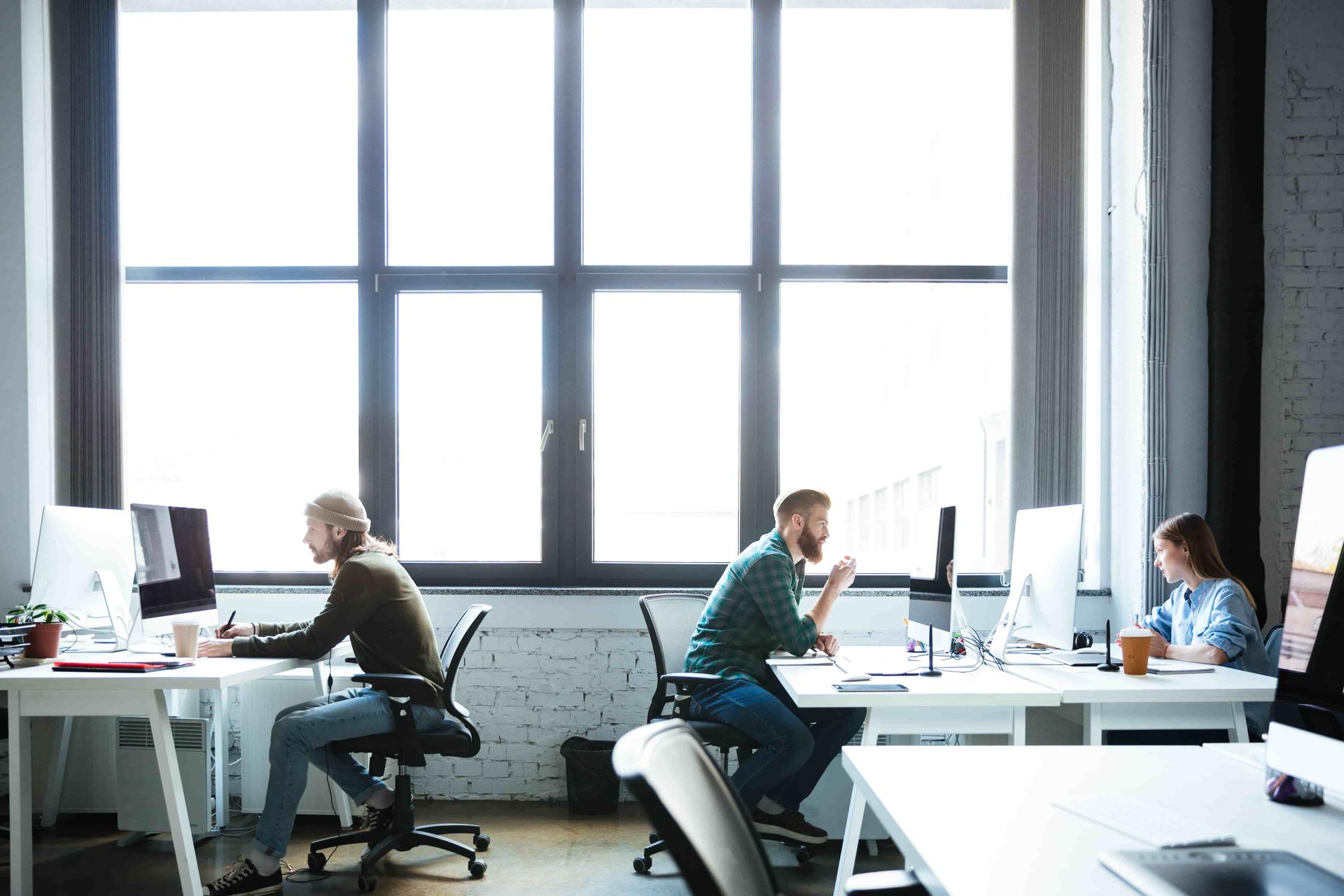 young-colleagues-work-office-using-computers-min
