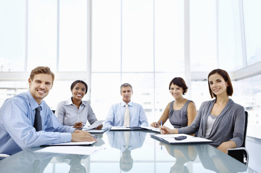 Portrait of multi racial business people smiling together in meeting