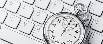 Close up of analog stopwatch on a laptop keyboard with copy space